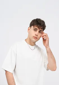 Detailed shot of a premium white 180g combed cotton T-shirt worn by a male model.
