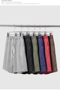 Detail of multi-colored washed cotton shorts hanging on a rack for a vintage summer look