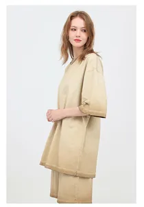 Side view of an oversized washed cotton T-shirt with a beige gradient effect.
