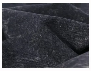 Macro view showing the texture of heavyweight washed distressed black cotton fabric