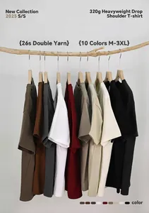 Variety of colored heavyweight drop shoulder T-shirts hanging on wooden hangers.