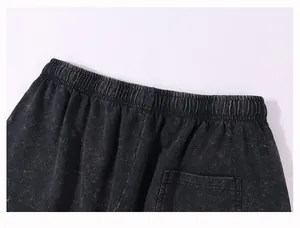Close-up detail of heavyweight cotton washed distressed shorts waist and back pocket