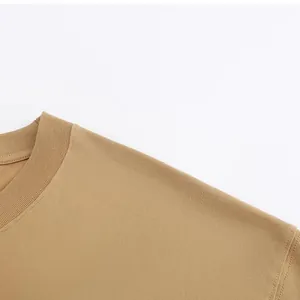 Close-up of the ribbed crew neck and dropped shoulder of a khaki heavy cotton T-shirt