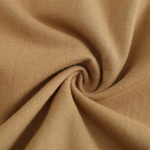 Close-up view of high-quality 270g pure cotton brown jersey fabric texture with folds