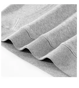 Close-up of grey hoodie ribbed hem showing thick fleece fabric texture and stitching.