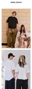 Detailed view of oversized drop shoulder cotton t-shirts on male and female models.