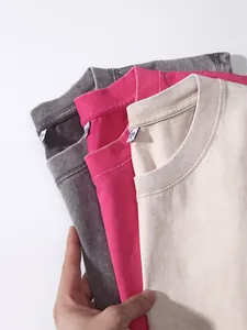 Close-up of washed distressed cotton tank tops showing collar detail and fabric texture