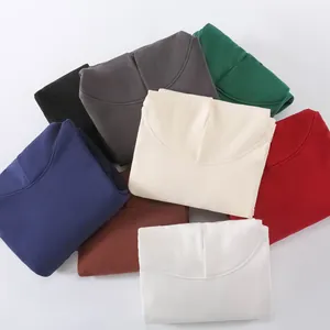 Assorted colors of folded heavyweight fleece hoodies in a professional top view image