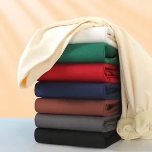 Neatly stacked heavy fleece hoodies in various colors showcasing soft material and warm tones