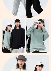 Lifestyle view of 360g oversized crew neck couple sweatshirts in sage green and black