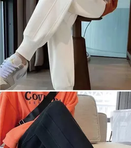 Detail showing the ribbed cuffs and soft fabric of white and black jogger sweatpants