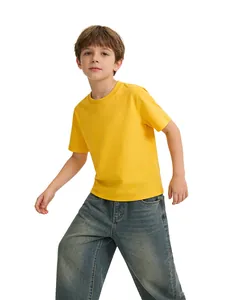 Young boy wearing vibrant yellow pure cotton round neck short sleeve T-shirt in studio setting