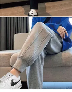 Detailed close-up of gray fleece joggers featuring elastic cuffs for a comfortable relaxed fit.
