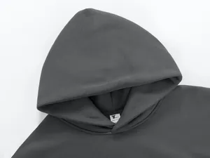 Close-up detail of a heavyweight charcoal grey hoodie hood and inner collar label