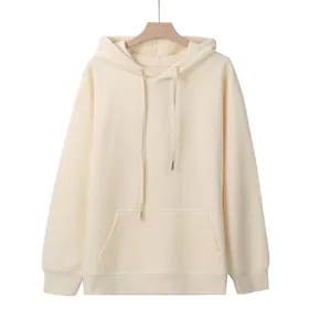 Front view of an oversized cream-colored hoodie featuring a drawstring hood and pocket.