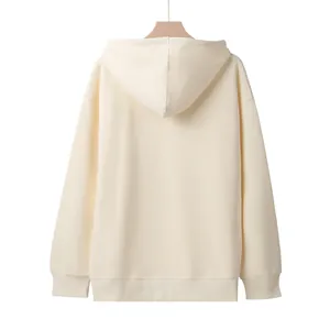 Detailed back view of a minimalist cream-colored oversized hoodie showing the hood texture