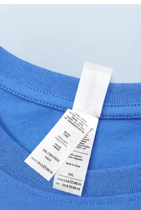 Detailed close-up of a blue cotton T-shirt showing dual Asian and European size labels