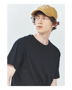 Side profile of a model wearing a premium 180G black cotton crew neck basic t-shirt