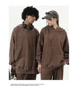Professional macro view of oversized retro distressed hoodie with washed texture on models