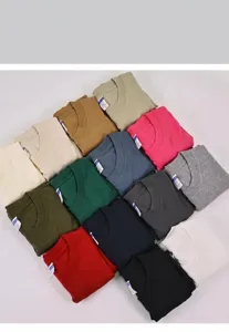 Macro detail showing a variety of folded heavyweight cotton crew neck T-shirts in multiple colors