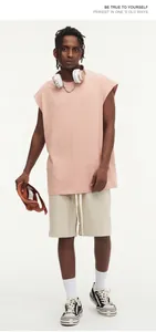 Loose pink sleeveless streetwear vest worn by male model in trendy casual outfit