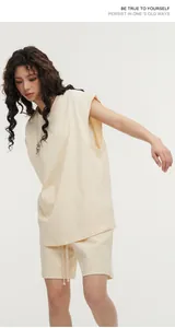 Asian model wearing a heavyweight cream sleeveless vest and matching shorts set.