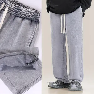 Grey acid-washed heavy cotton sweatpants with adjustable drawstring waistband and cuffs