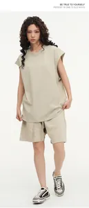 Street style oversized beige sleeveless t-shirt and matching shorts set worn by model