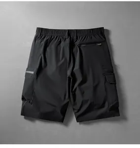 Rear view of black quick-dry cargo shorts showing zipper and flap pocket details.