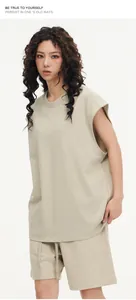 Professional model wearing an oversized beige sleeveless tank top and shorts streetwear set