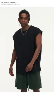 Detailed view of an oversized black sleeveless tank top in heavyweight fabric.