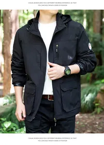 Detailed visual of a men's black windproof outdoor jacket in a forest setting