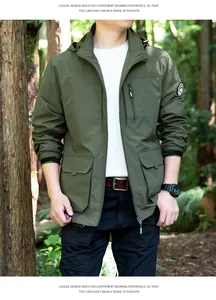 Man wearing a green windproof outdoor jacket in a forest setting