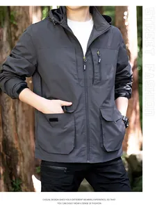Close-up detail of dark grey men's outdoor windproof jacket with multi-pocket design