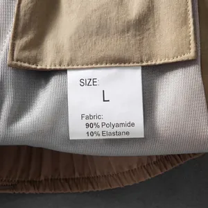 Close-up of quick-dry cargo shorts showing the fabric composition and size label tag.