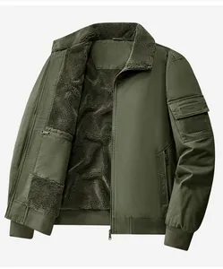 Close-up detail of army green bomber jacket featuring warm grey sherpa fleece lining and pocket