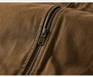 Detailed close-up view of the durable metal zipper on a brown washed cotton flight jacket