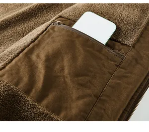 Close-up of brown men's flight jacket showing a zippered pocket and fleece texture.