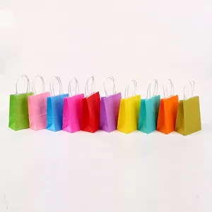 Row of ten colorful mini kraft paper gift bags with white string handles for party favors.
