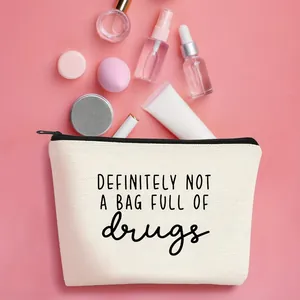 Close-up detail of durable canvas makeup pouch with funny humor slogan on pink background