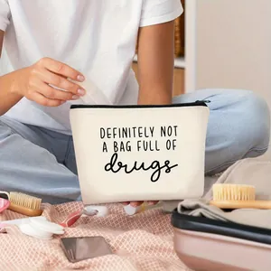 Lifestyle detail of a canvas makeup bag with a humorous quote for daily organizing