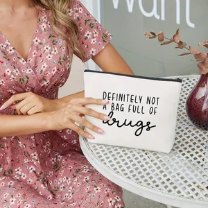 White canvas makeup bag with satirical 'DEFINITELY NOT A BAG FULL OF drugs' print