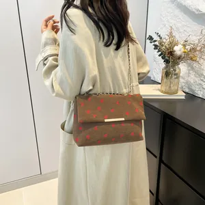 Stylish brown corduroy crossbody bag with cute strawberry print and gold chain strap.