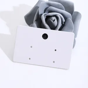 Close-up of blank white cardboard earring display cards for jewelry packaging