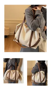 Detailed view of the large canvas tote bag showing stitching and leather strap details