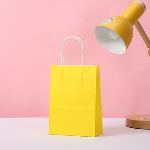 Simple bright yellow kraft paper gift bag with white twisted handles for DIY party favors