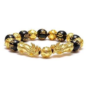 Detailed shot of black obsidian Pixiu bracelet with gold Six-Syllable Mantra beads