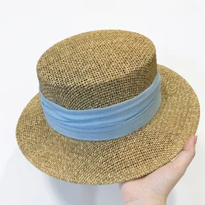 Classic French flat-top straw hat with light blue ribbon for summer sun protection
