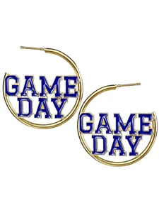 Détail des lettres Game Day en émail bleu sur des créoles dorées en forme de C