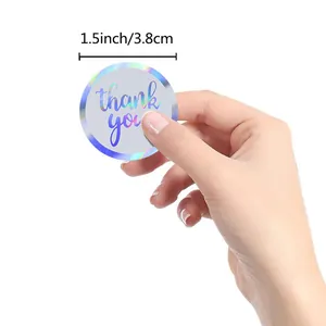 Close-up detail of a 1.5 inch holographic thank you sticker for gift seal packaging